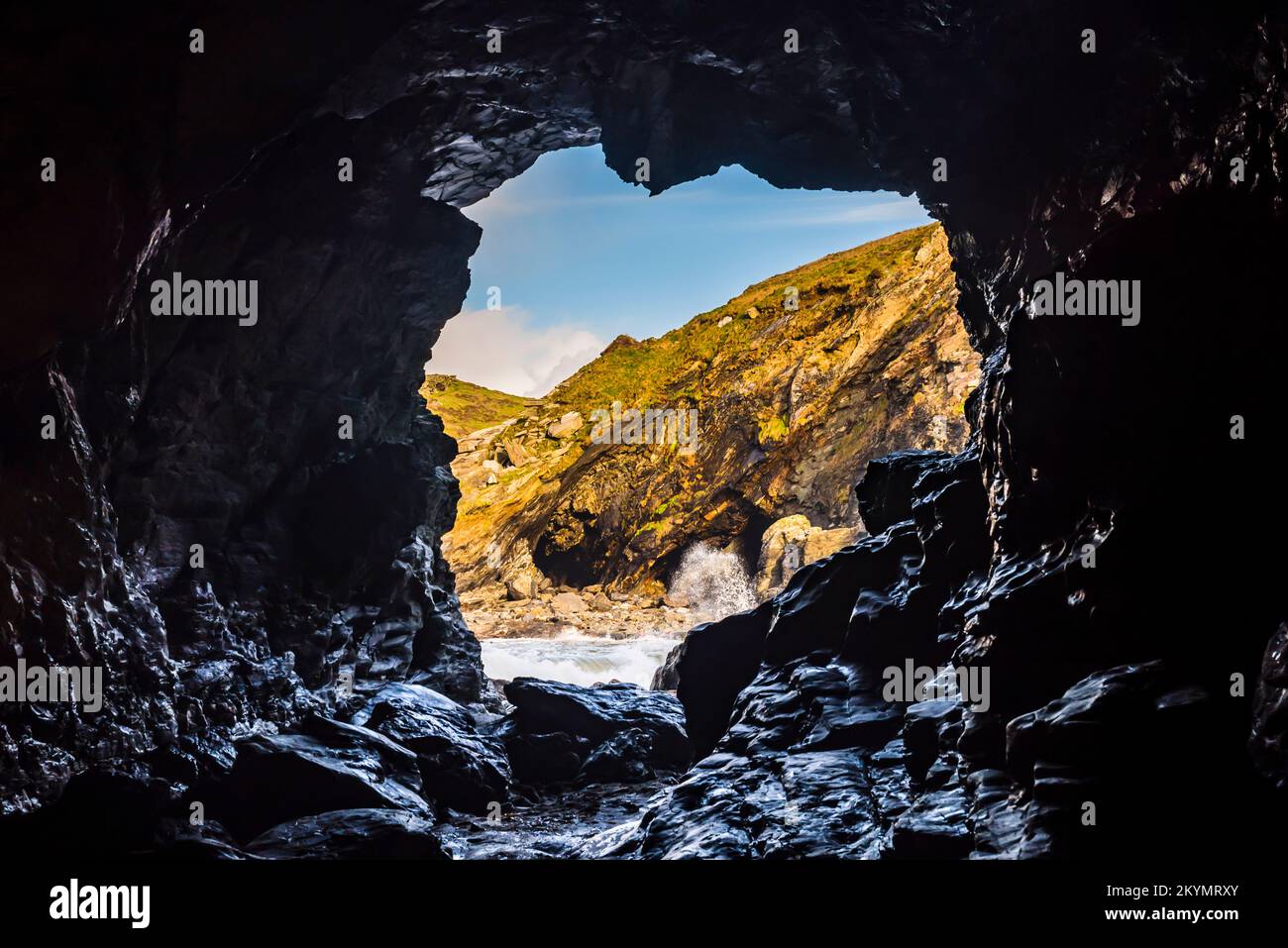 Looking through Merlin's Cave to surf on the beach at Tintagel Haven