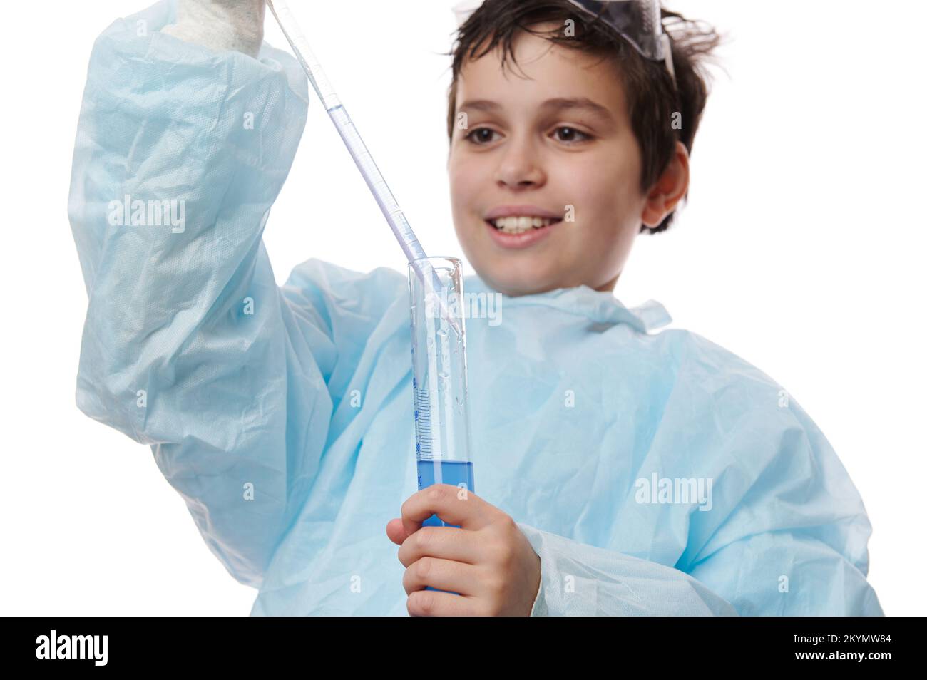 Closeup teenage boy, chemist scientist, filling graduated pipette with