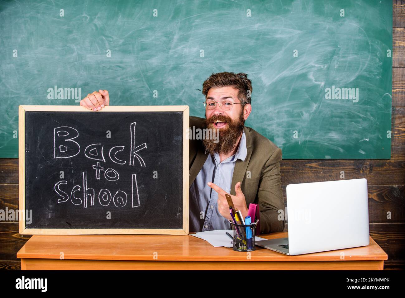 Teacher or school principal with blackboard inscription back