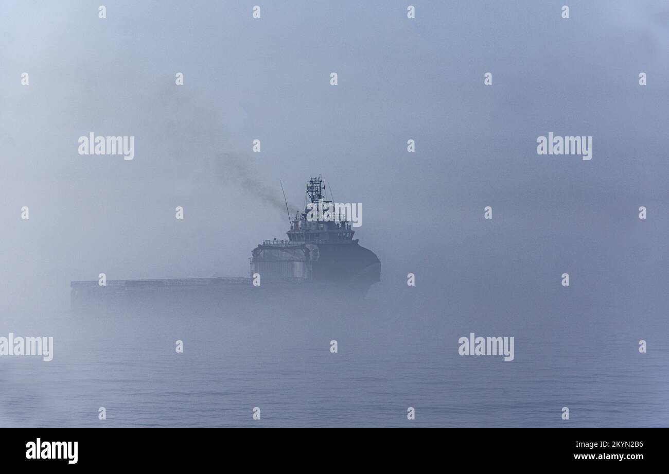 Vessel waiting for clearance to enter port a foggy day Stock Photo - Alamy