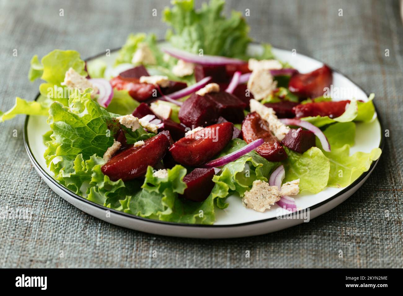 Home made beet and plum salad with vegan feta. Stock Photo
