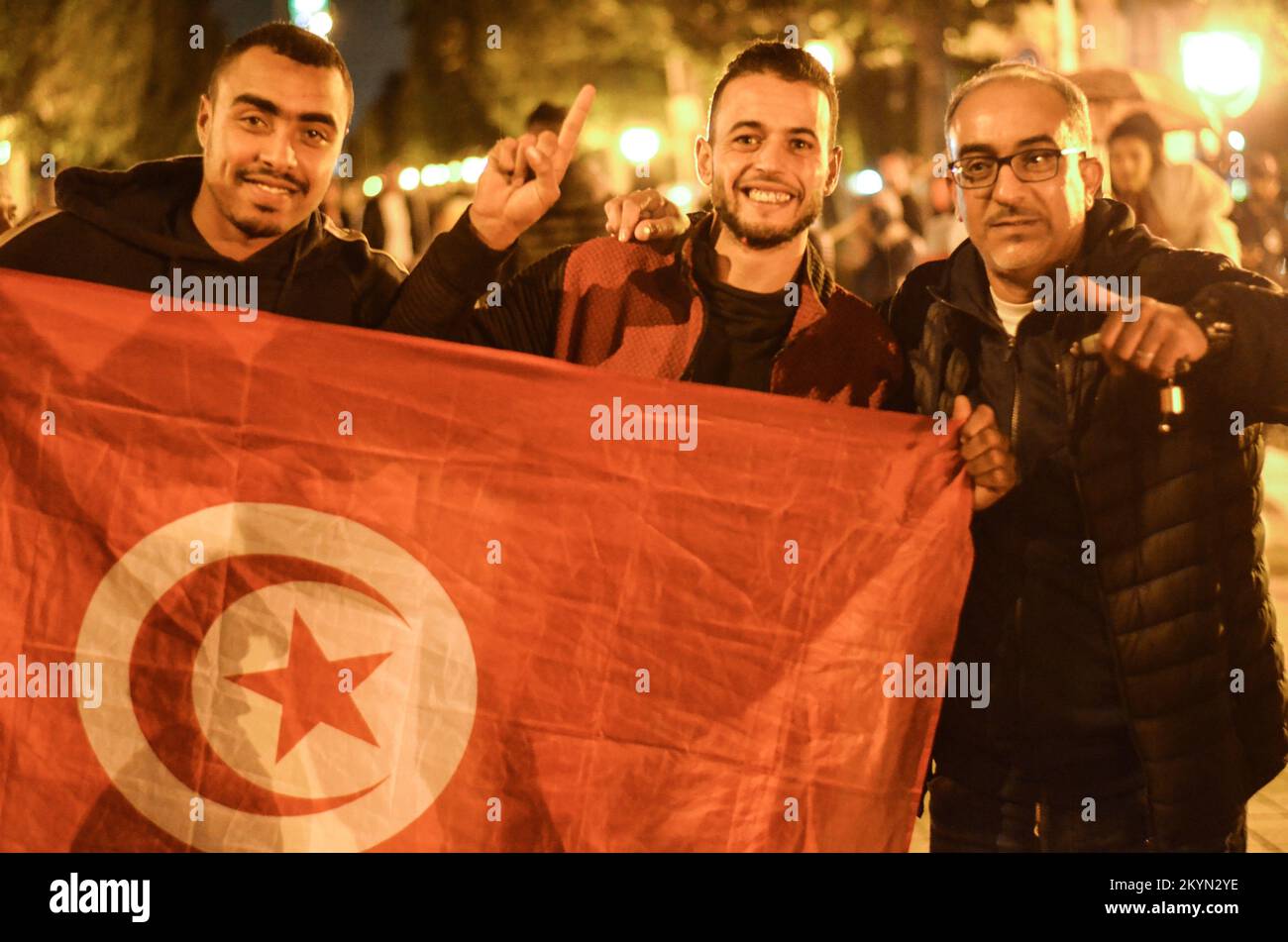 Tunis, Tunisia. 30th Nov, 2022. Tunis, Tunisia. 30 November 2022. Tunisian football fans celebrate along the Habib Bourguiba Avenue in Tunis after their victory against France in the Qatar World Cup. Tunisia beat France 1-0 on Wednesday. Although the Tunisian team failed to qualify for the last 16 of the World Cup, Tunisian fans held big celebrations after their team's latest match at the 2022 World Cup (Credit Image: © Hasan Mrad/IMAGESLIVE via ZUMA Press Wire) Stock Photo