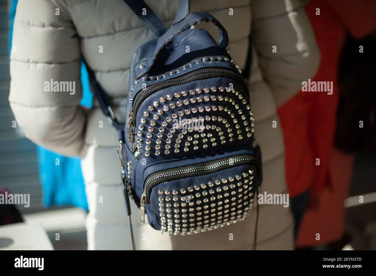 Backpack made of rivets. Pack rivets on bag. Fashionable backpack on girl. Stock Photo