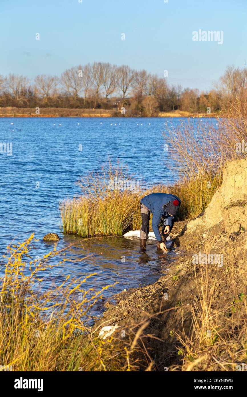 Man looking for fossils at an old clay pit site in Yaxley, Cambridgeshire, UK Stock Photo
