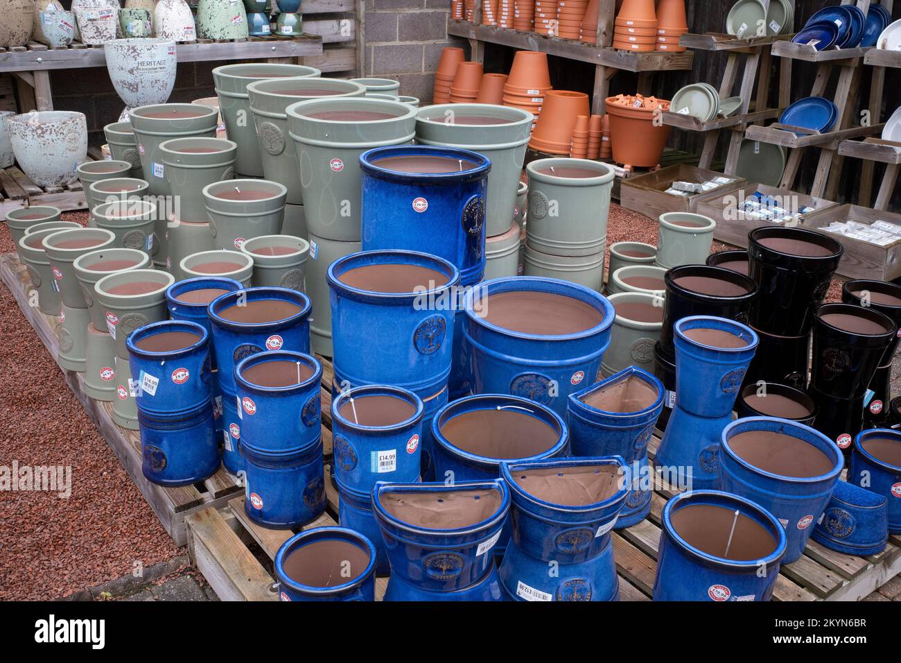 A display of bright blue grey and black glazed clay flower pots on offer at a garden centre in North Yorkshire Stock Photo