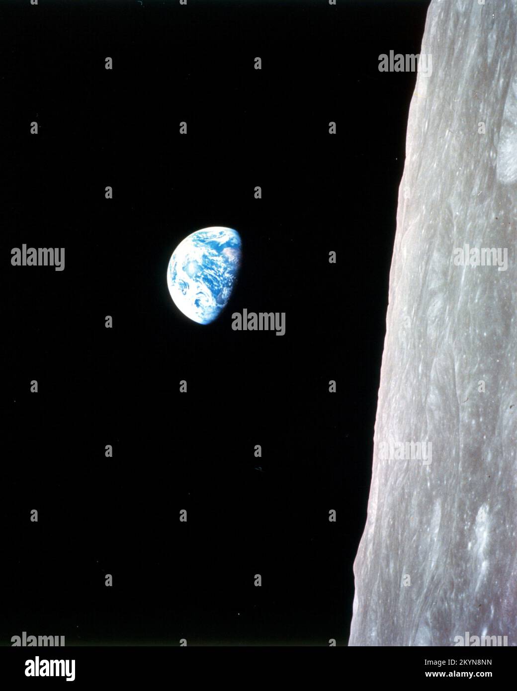 This view of the rising Earth greeted the Apollo 8 astronauts as they came from behind the Moon after the fourth nearside orbit. The photo is displayed here in its original orientation, though it is more commonly viewed with the lunar surface at the bottom of the photo. Earth is about five degrees left of the horizon in the photo. The unnamed surface features on the left are near the eastern limb of the Moon as viewed from Earth. The lunar horizon is approximately 780 kilometers from the spacecraft. Height of the photographed area at the lunar horizon is about 175 kilometers. Stock Photo