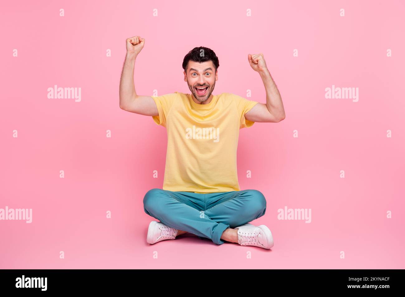 Photo of positive nice man raise muscular arms support football team