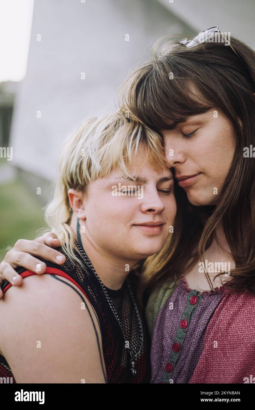 Young couple with eyes closed embracing each other Stock Photo