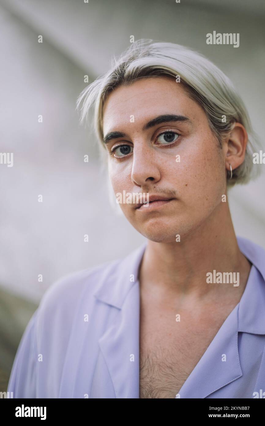 Portrait of non-binary person with medium-length hair Stock Photo