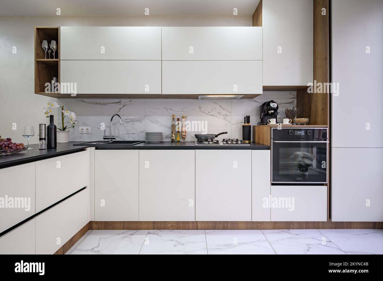 Large black and white luxury kitchen interior, whole front view Stock