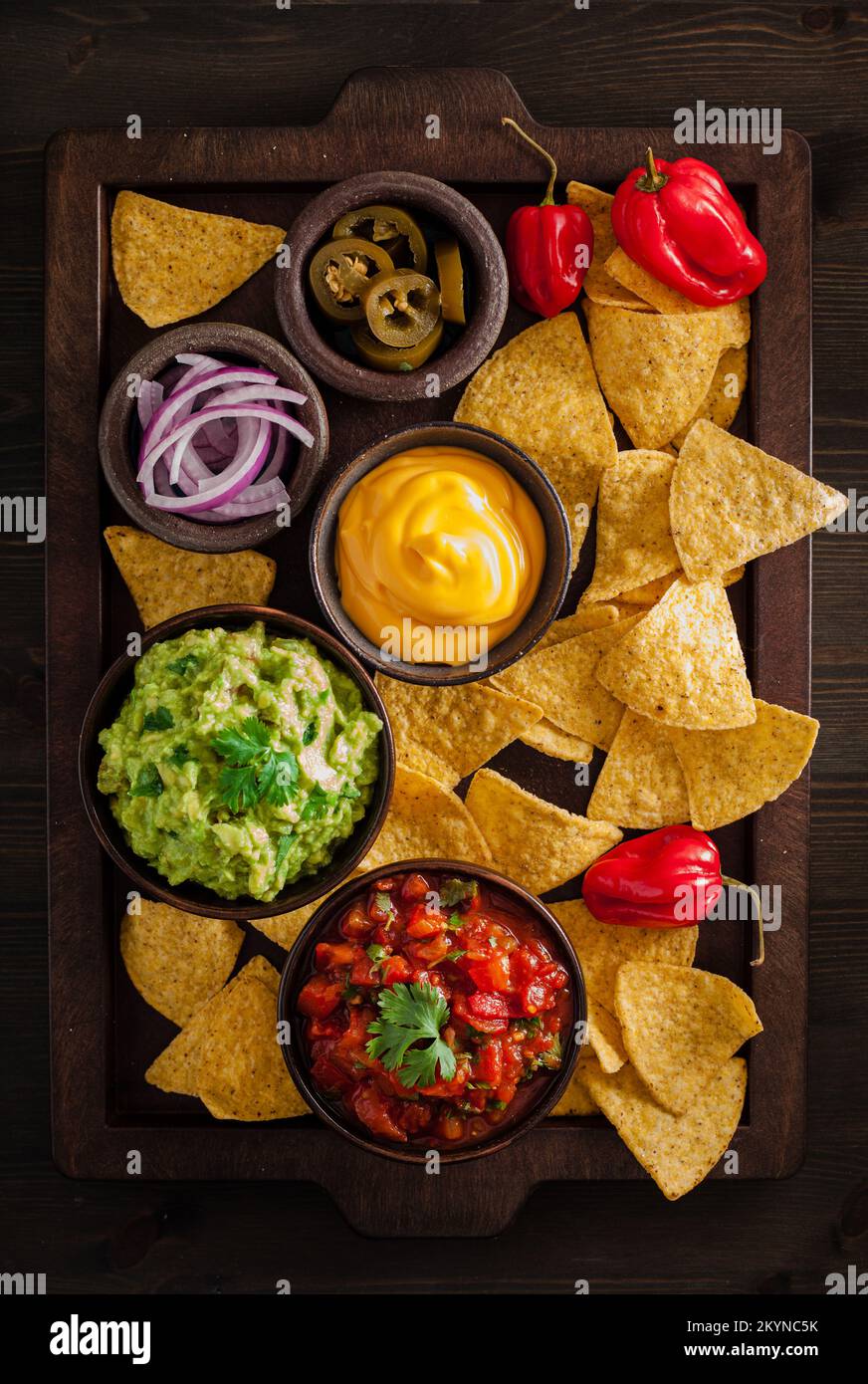 mexican nachos tortilla chips with guacamole, salsa and cheese dip Stock Photo