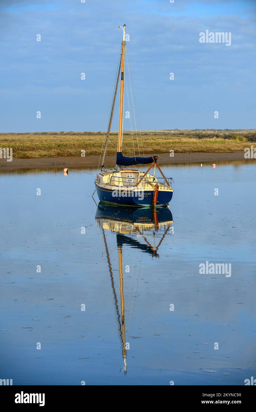 Boats caught by late afternoon light in the harbour at Burnham Overy ...