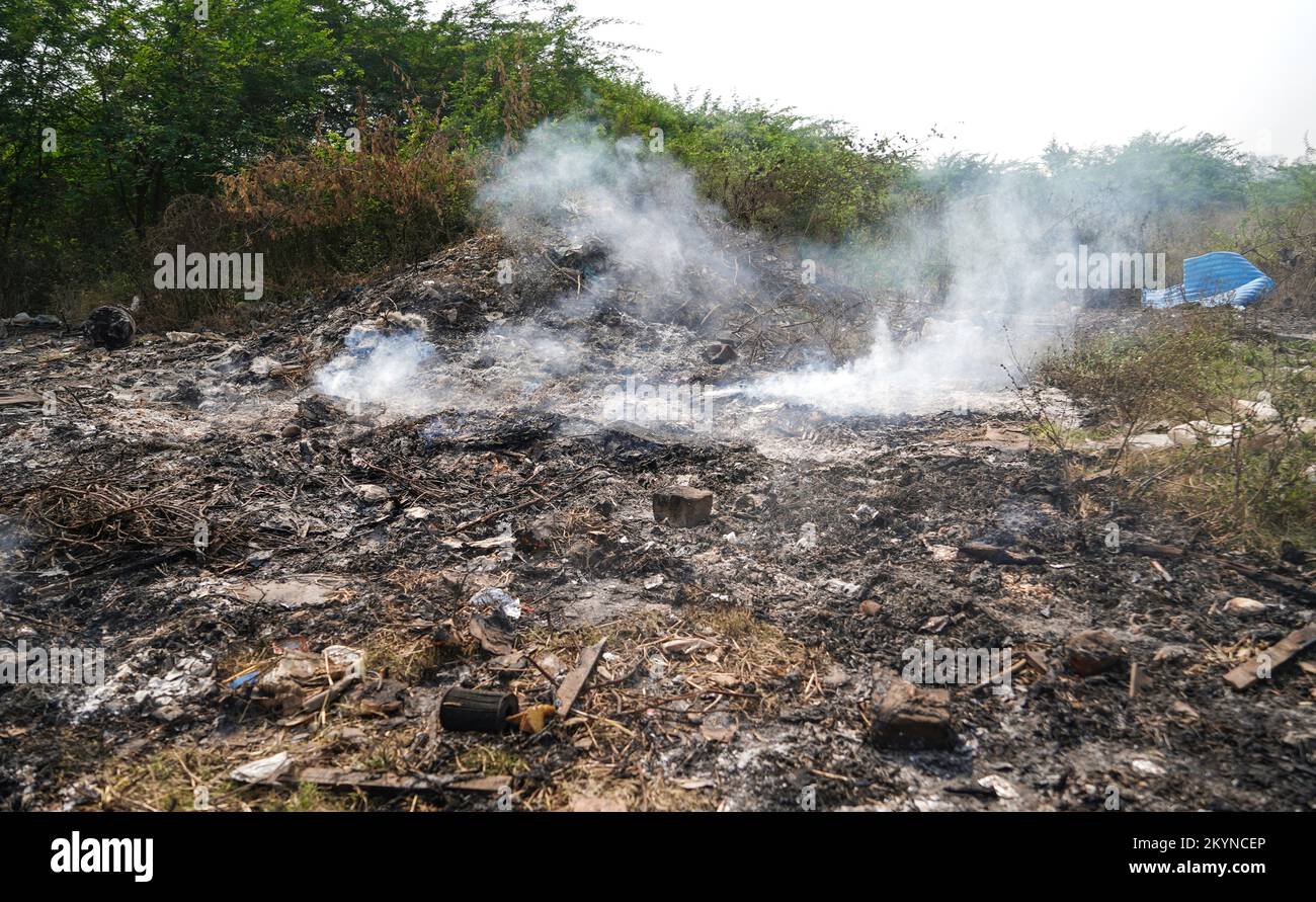 Garbage Dumping and burning site creating air pollution by smoke, pollution control day, land pollution, Raipur, india Stock Photo