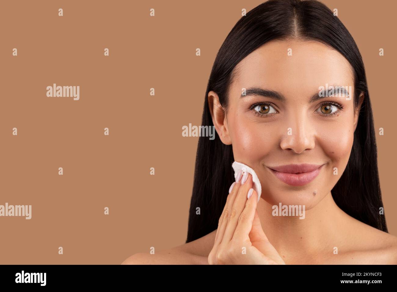 Closeup of pretty young woman using peeling cotton pad Stock Photo