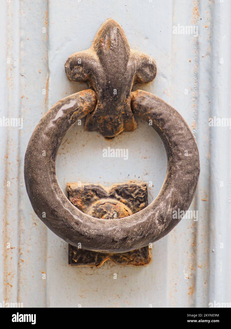 Antique door knocker on antique wooden door. Old Maltese architectural