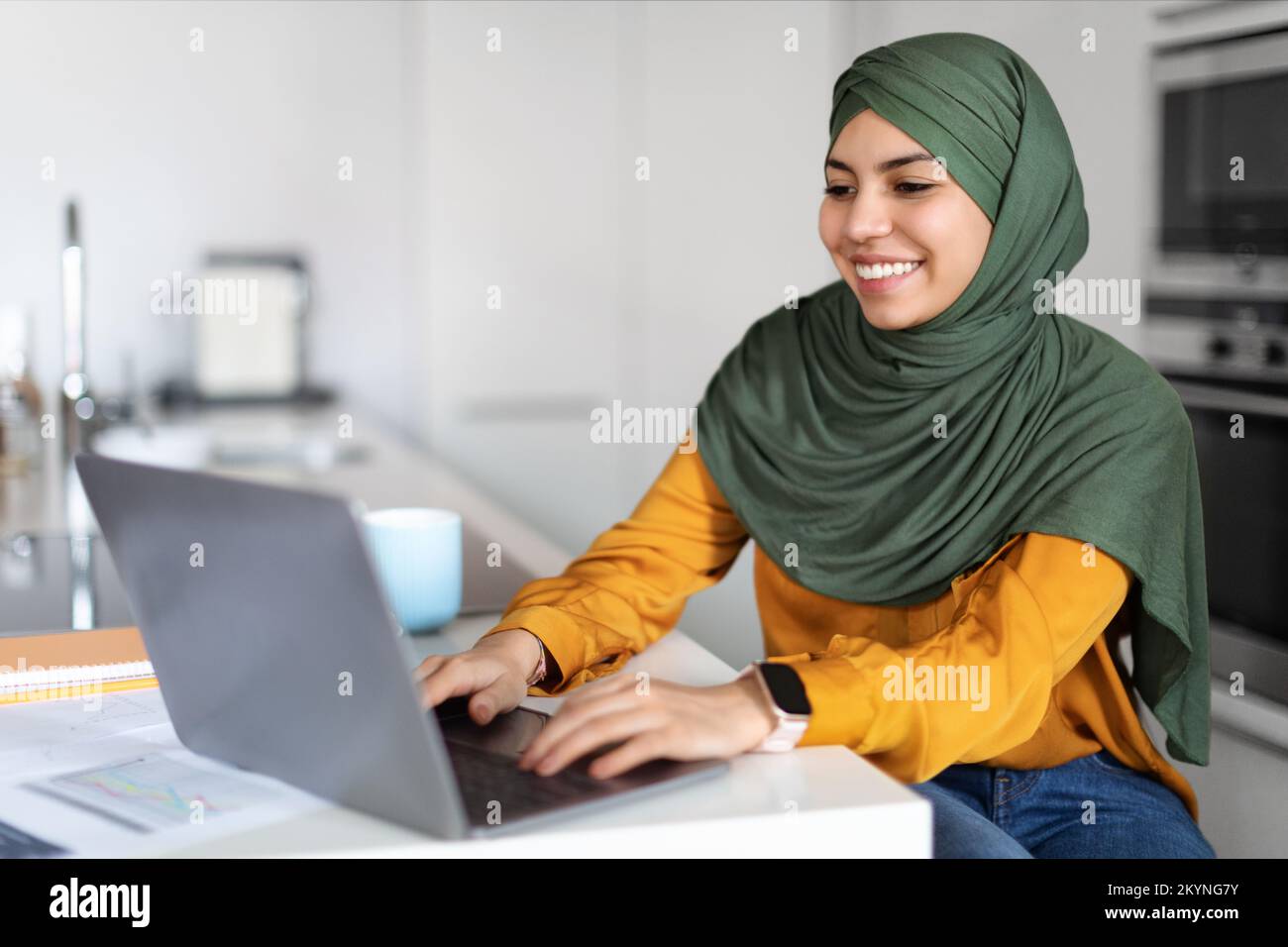 Remote Work. Muslim Female Freelancer In Hijab Using Laptop While Working At Home Stock Photo
