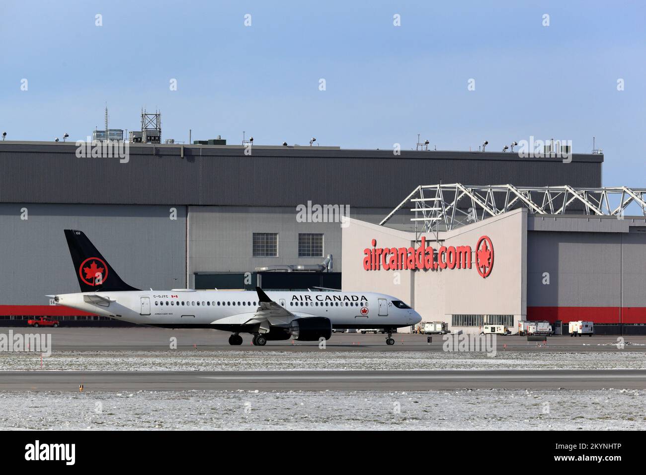 Airbus A220-300 Air Canada C-GJYC taxiing by Air Canada building at YUL, Montreal PET Airport, Quebec, Canada, November 22, 2022 Stock Photo