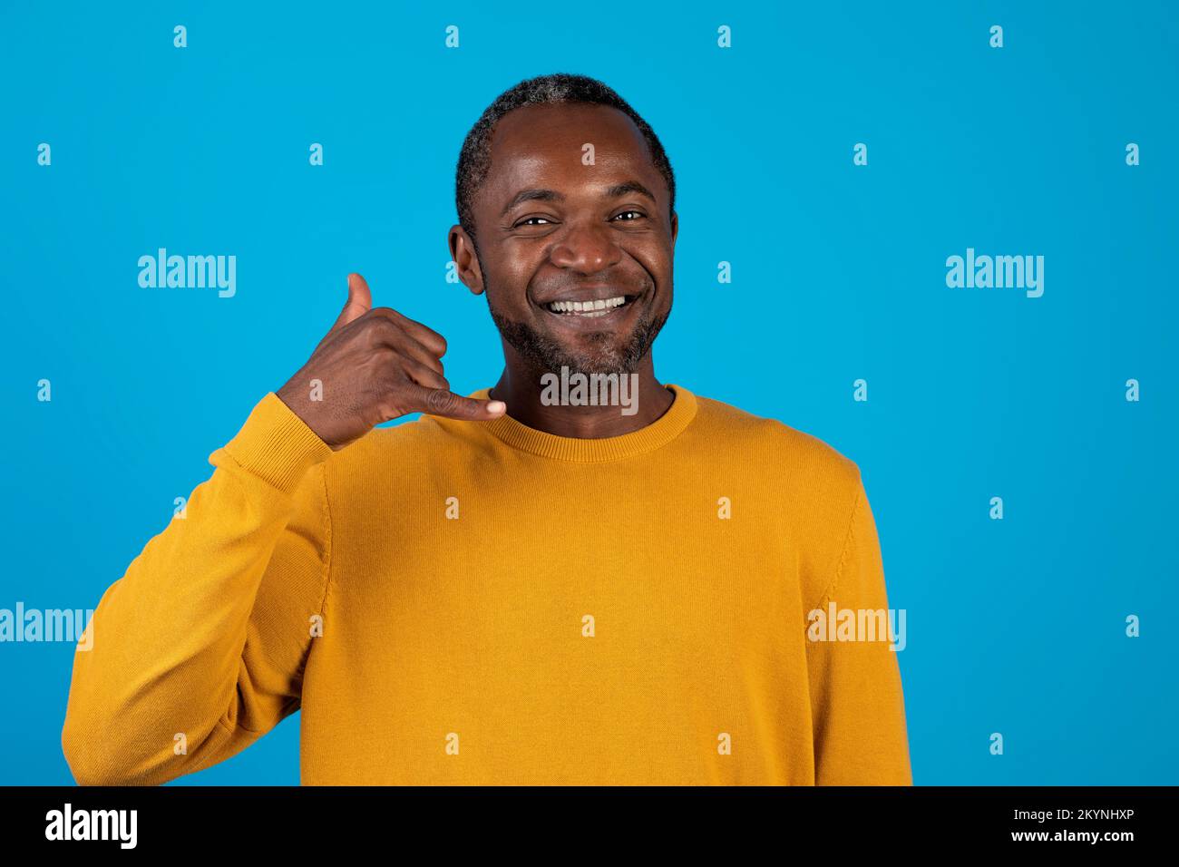 Handsome african american man showing a call me sign Stock Photo
