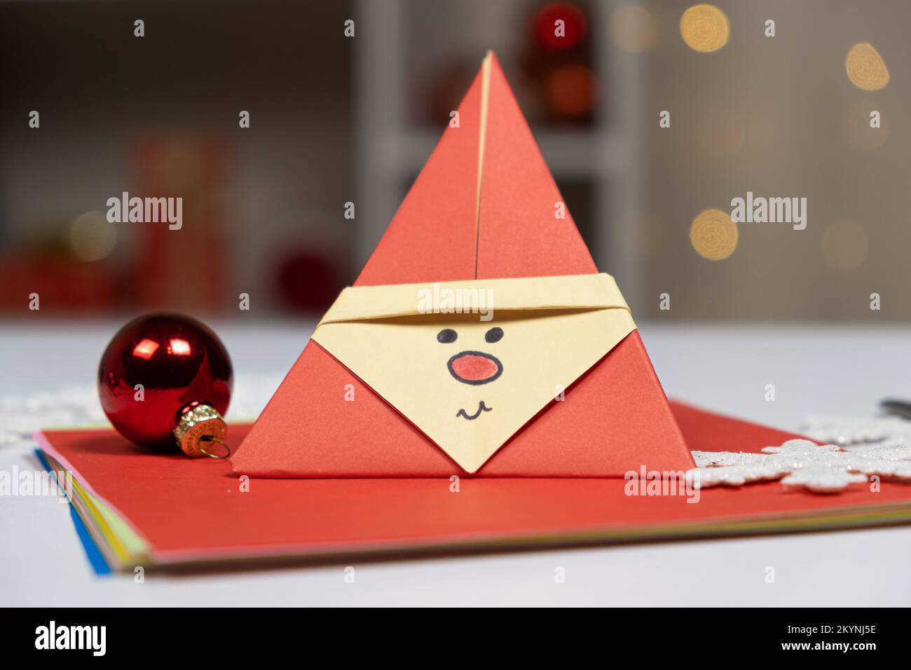 Christmas origami red Santa Claus paper, DIY for the New Year Stock Photo