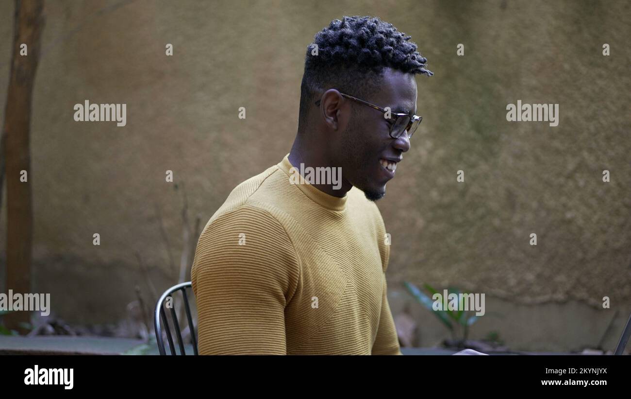 Smart young black African man smiling and laughing Stock Photo - Alamy