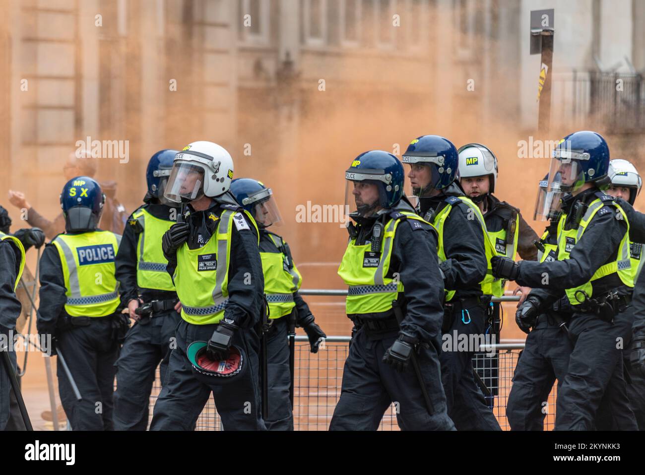 Supporters of Tommy Robinson, such as the EDL, protested in London demonstrating for his release after arrest. Riot police arriving, with smoke flares Stock Photo