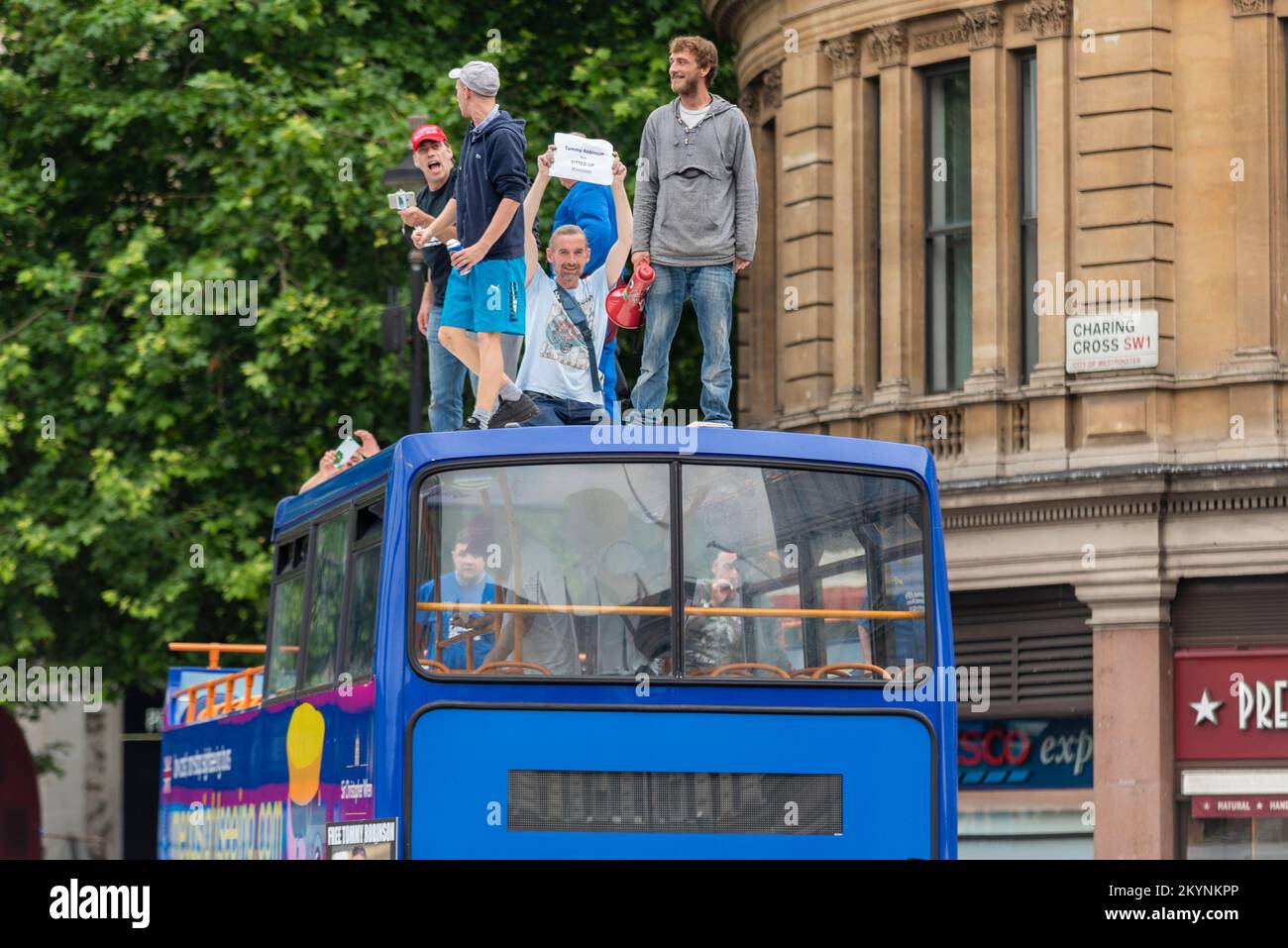 Supporters of Tommy Robinson, such as the EDL protested in London demonstrating for his release after arrest. Protesters climbed up onto tour bus roof Stock Photo