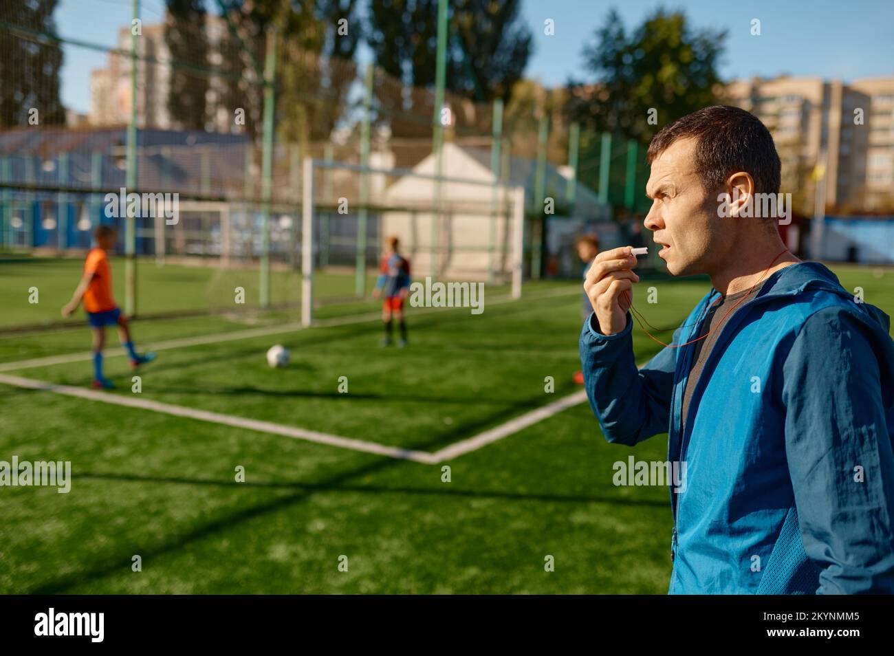 Confident soccer coach with whistle standing on pitch Stock Photo Alamy