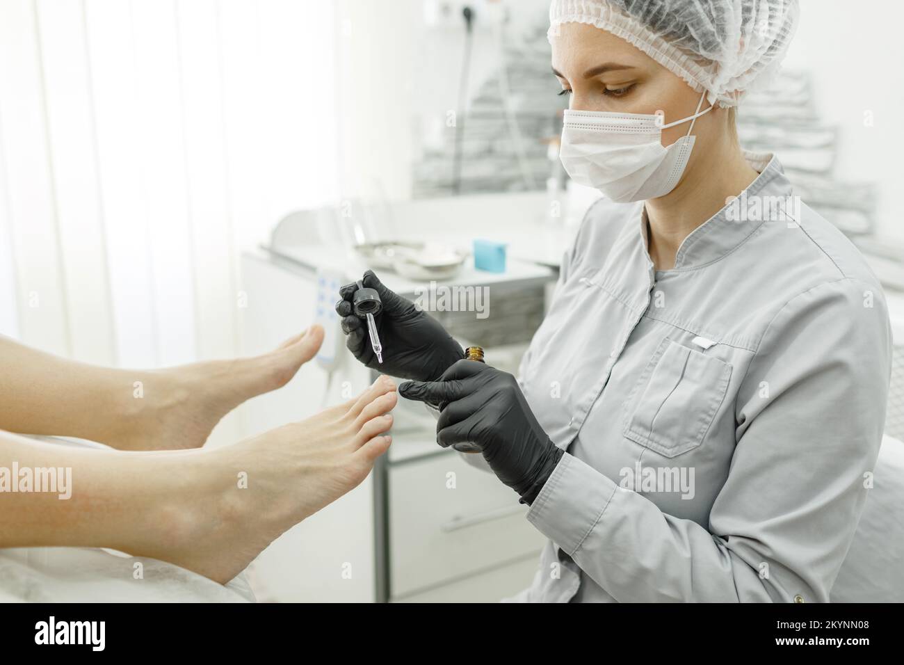 Therapeutic pedicure. The pedicure master applies a softening oil or a