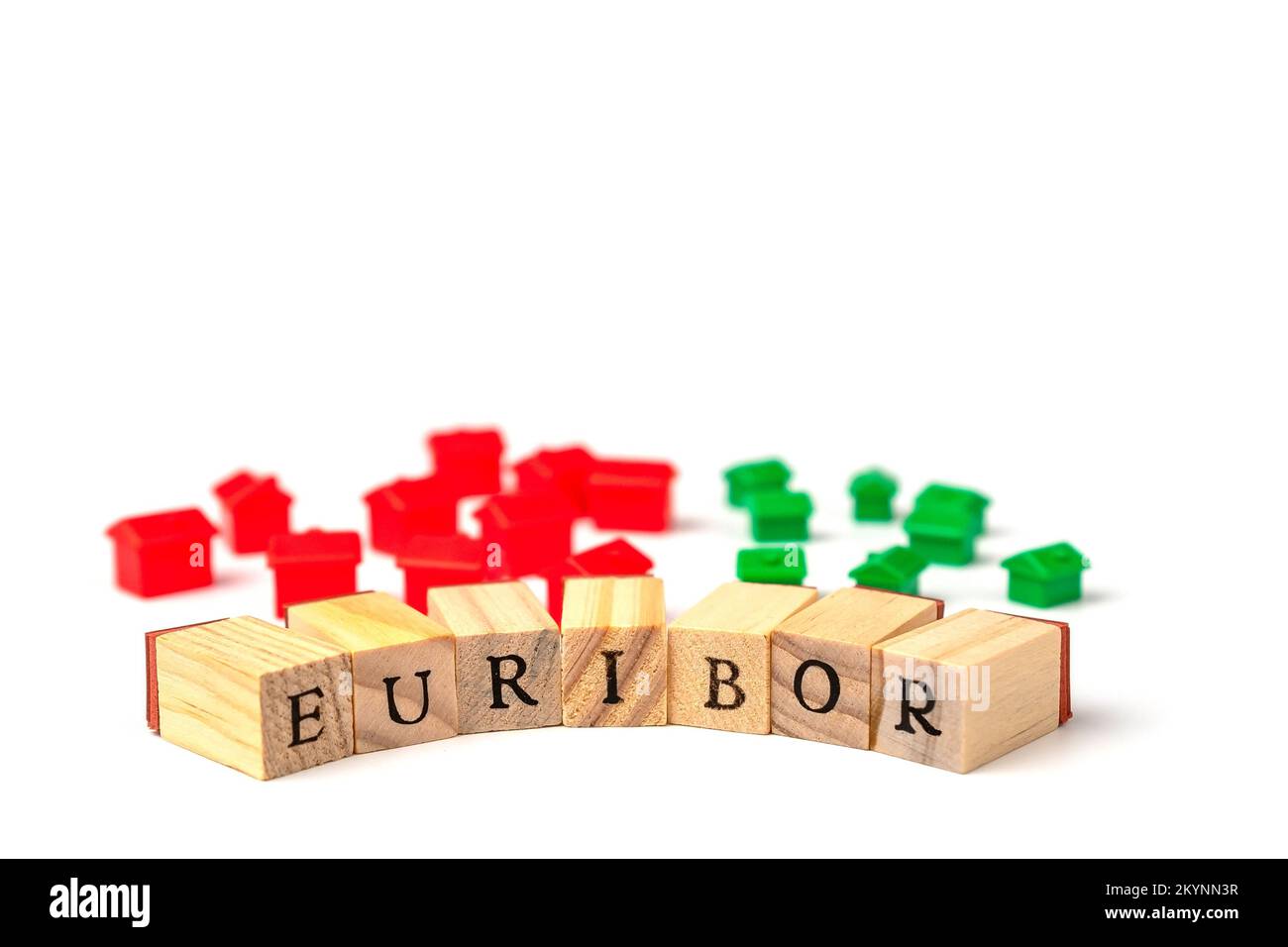 Word EURIBOR Is Written In Wooden Letters On White Background, Behind Small Houses of Red and Green Color. Copy paste. Concept of Decreasing Stock Photo