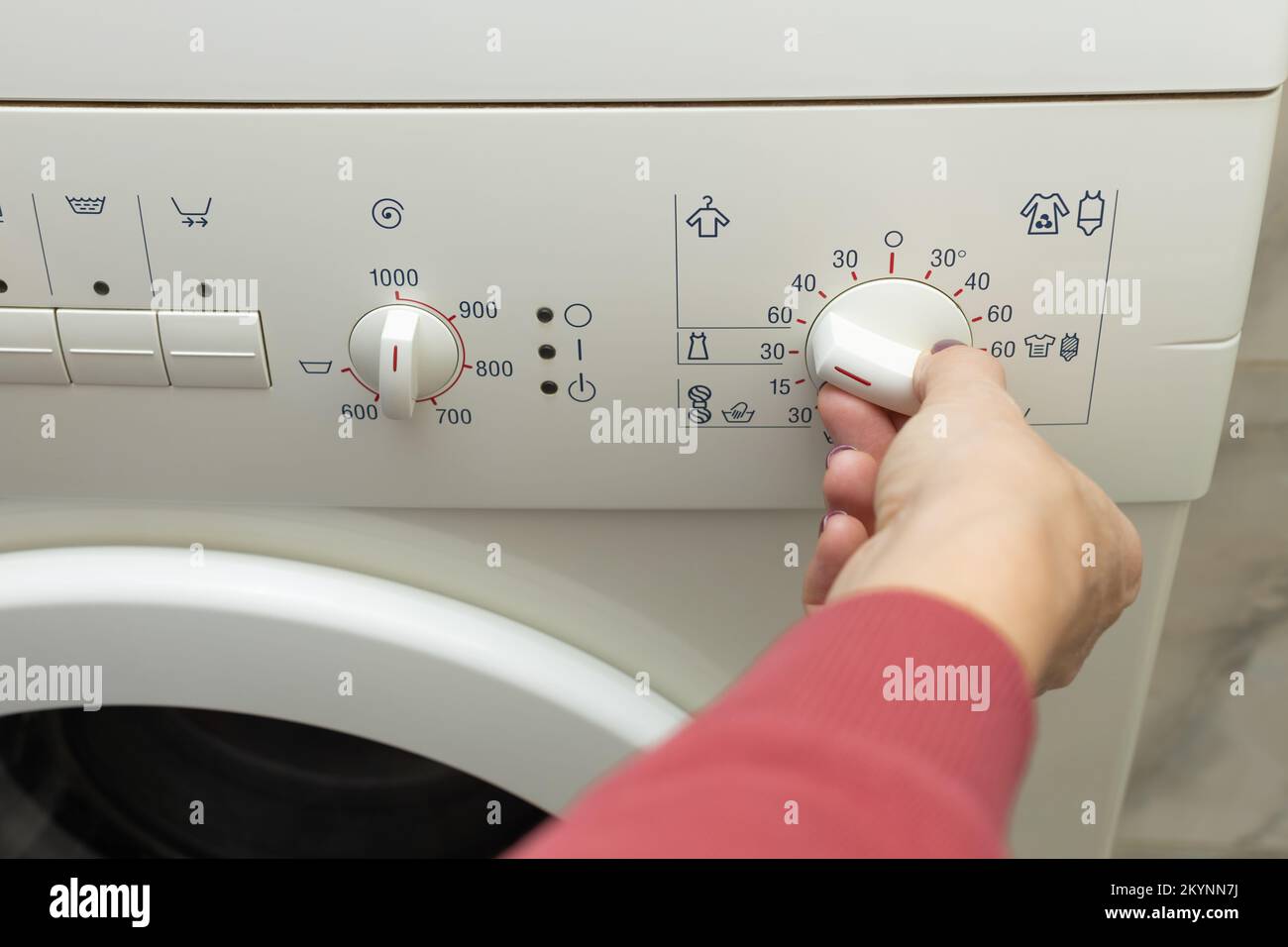 finger pressing the water drain button on the storage tank of the toilet  bowl and the toilet bowl at a shallow depth of field Stock Photo - Alamy