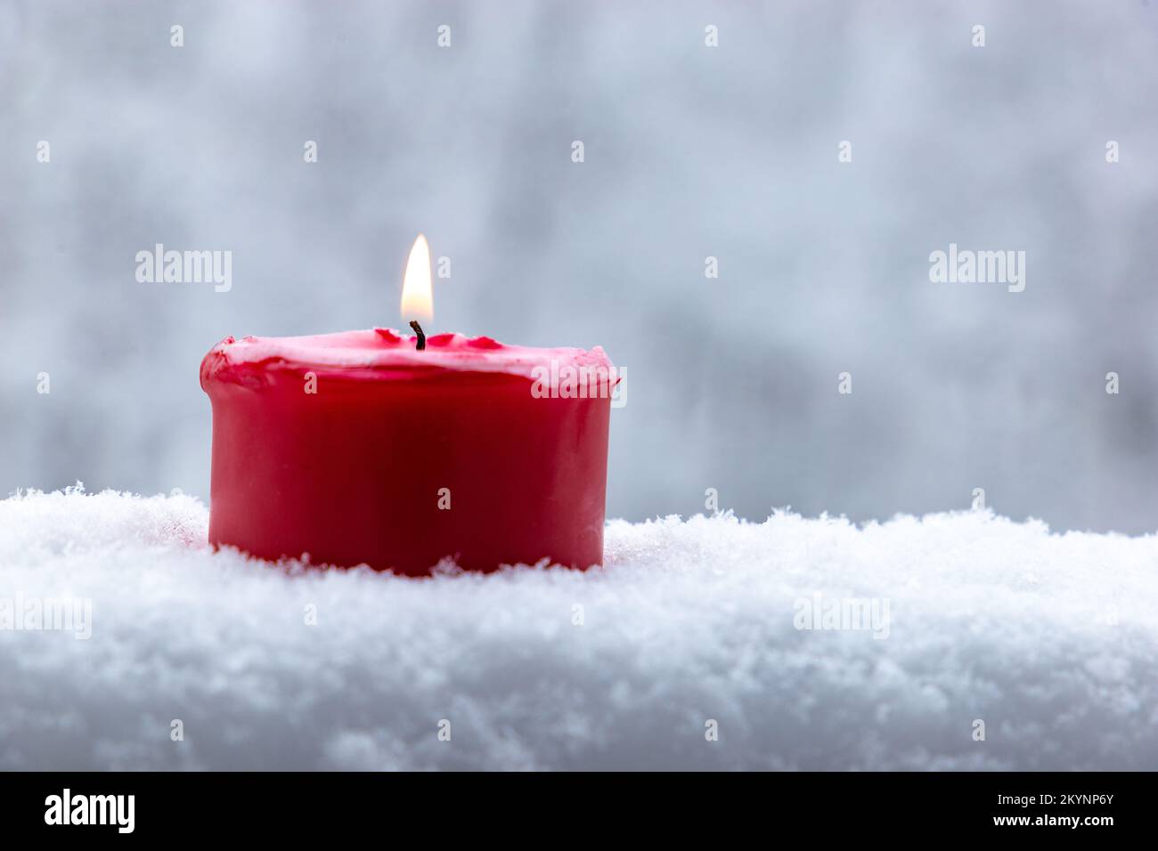 Candle burns and snow falls Stock Photo Alamy