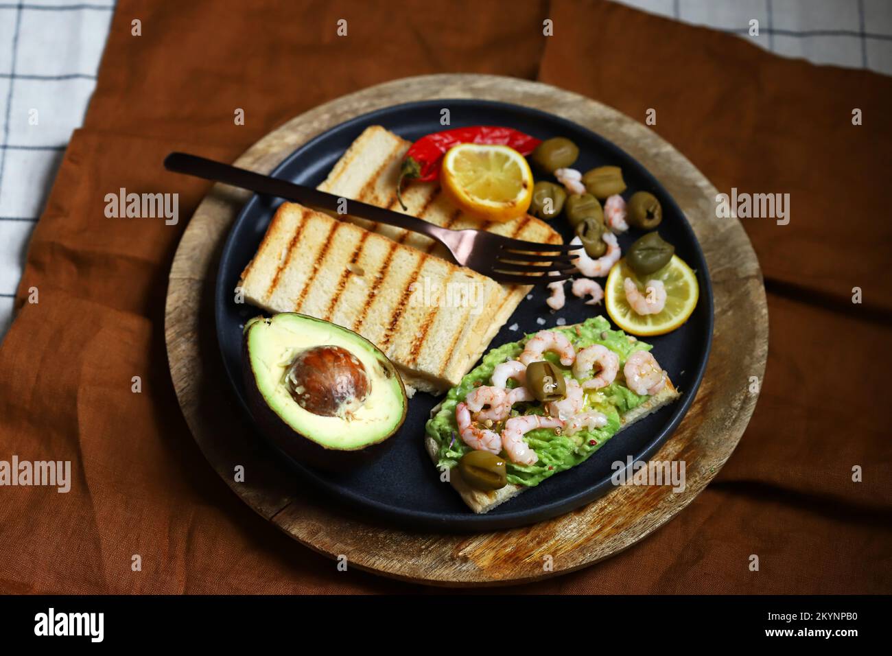 Guacamole toast with avocado, shrimp and olives. Healthy snack. Keto. Stock Photo