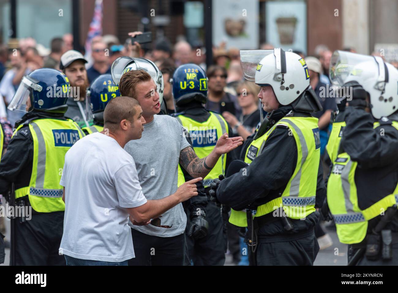 Supporters of Tommy Robinson, such as the EDL, protested in London demonstrating for his release after arrest. Protester with police officer Stock Photo