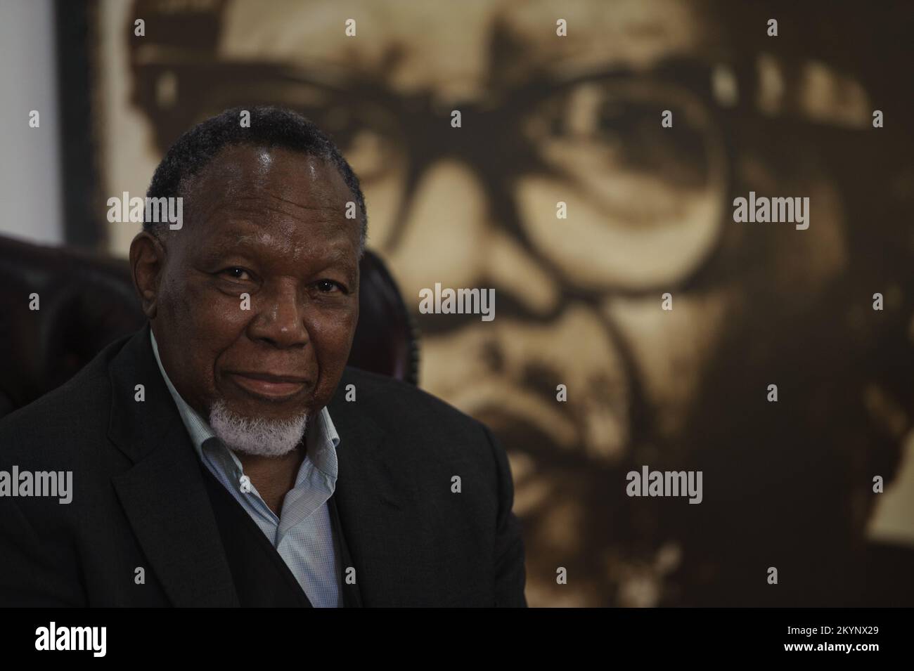 Former South Africa president Kgalema Motlanthe in the shadow of a portrait of ANC liberation icon and exiled leader during apartheid Oliver Tambo Stock Photo