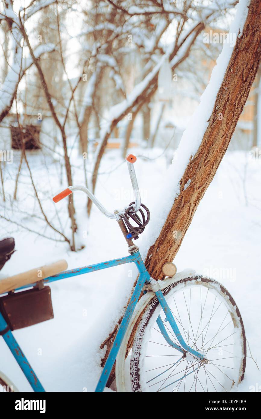 Old antique bike covered with snow in winter time Stock Photo
