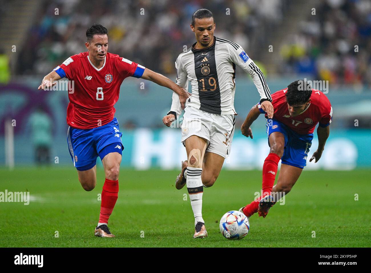 AL KHOR, QATAR - DECEMBER 1: Leroy Sane of Germany battles for the ball with Bryan Oviedo of Costa Rica and Yeltsin Tejeda of Costa Rica during the Group E - FIFA World Cup Qatar 2022 match between Costa Rica and Germany at the Al Bayt Stadium on December 1, 2022 in Al Khor, Qatar (Photo by Pablo Morano/BSR Agency) Stock Photo