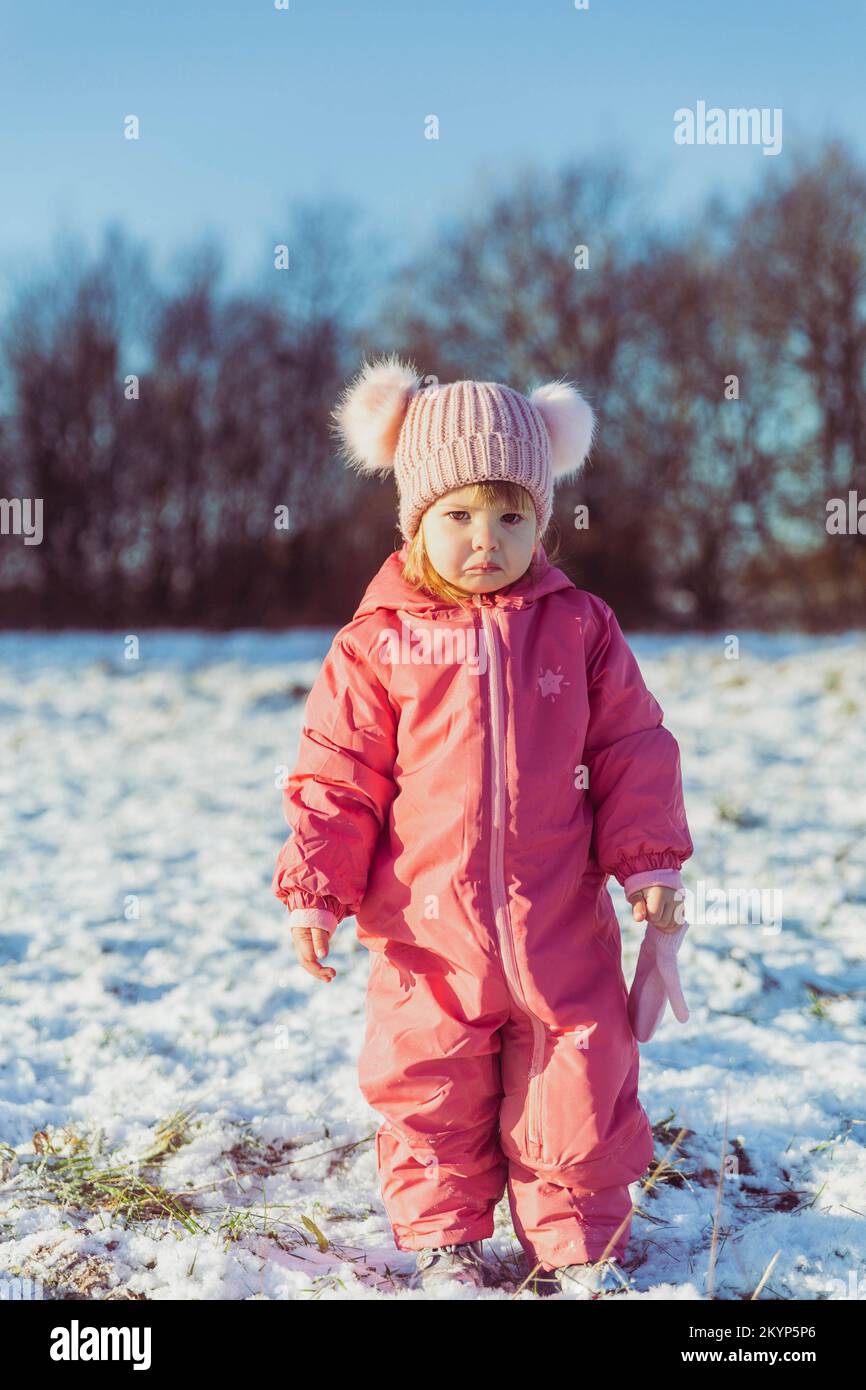 charming beautiful baby walks in winter park Stock Photo