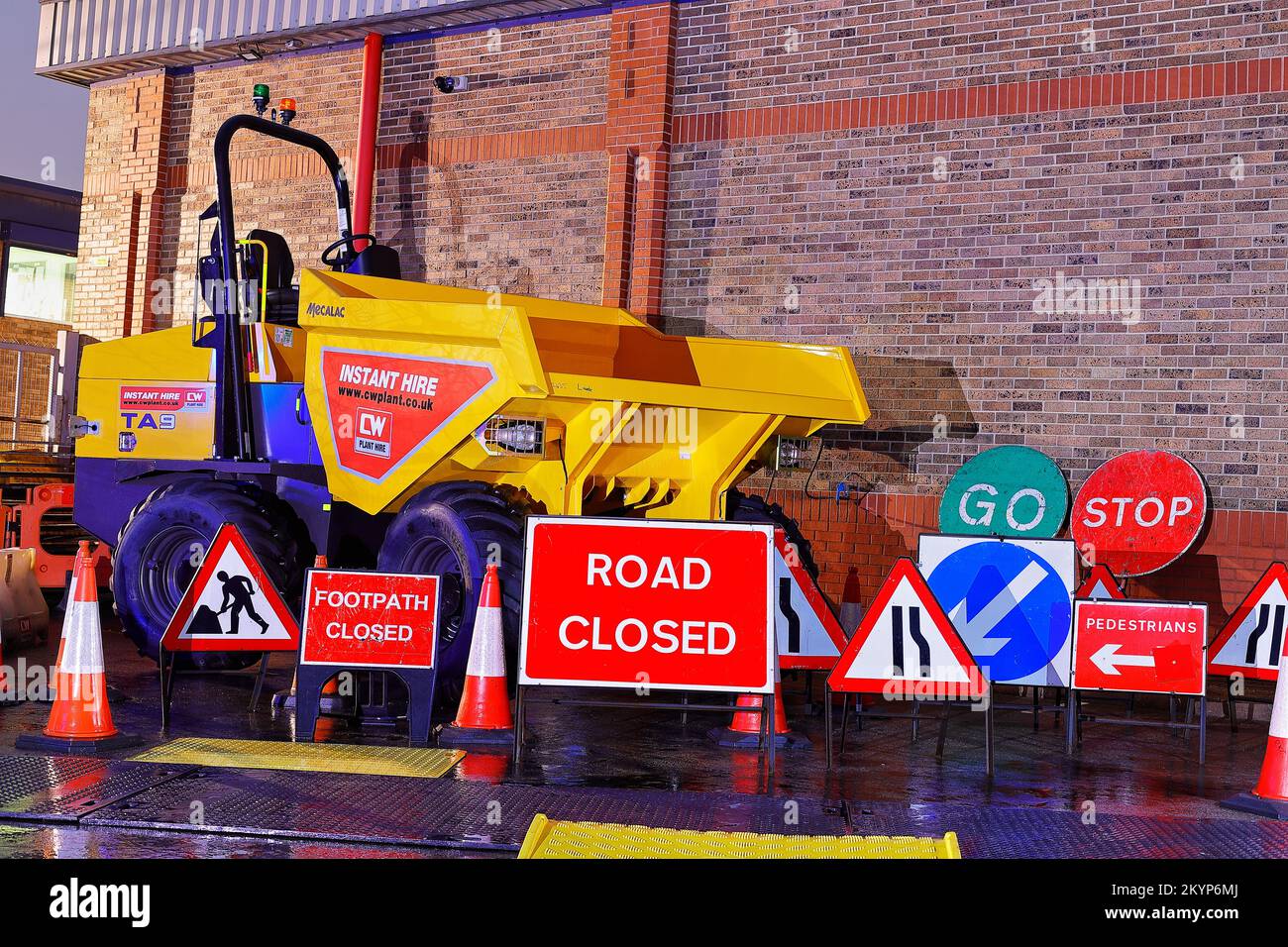 A 9 tonne forward tipping dump truck and road signs at a plant hire