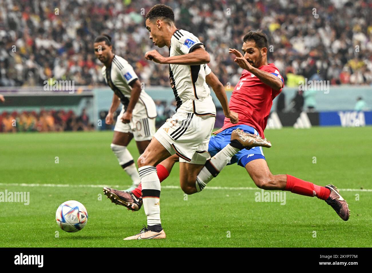 Al Chaur, Qatar. 01st Dec, 2022. Soccer: World Cup, Costa Rica - Germany, preliminary round, Group E, Matchday 3, Al-Bait Stadium, Germany's Jamal Musiala (l) plays against Costa Rica's Celso Borges. Credit: Federico Gambarini/dpa/Alamy Live News Stock Photo