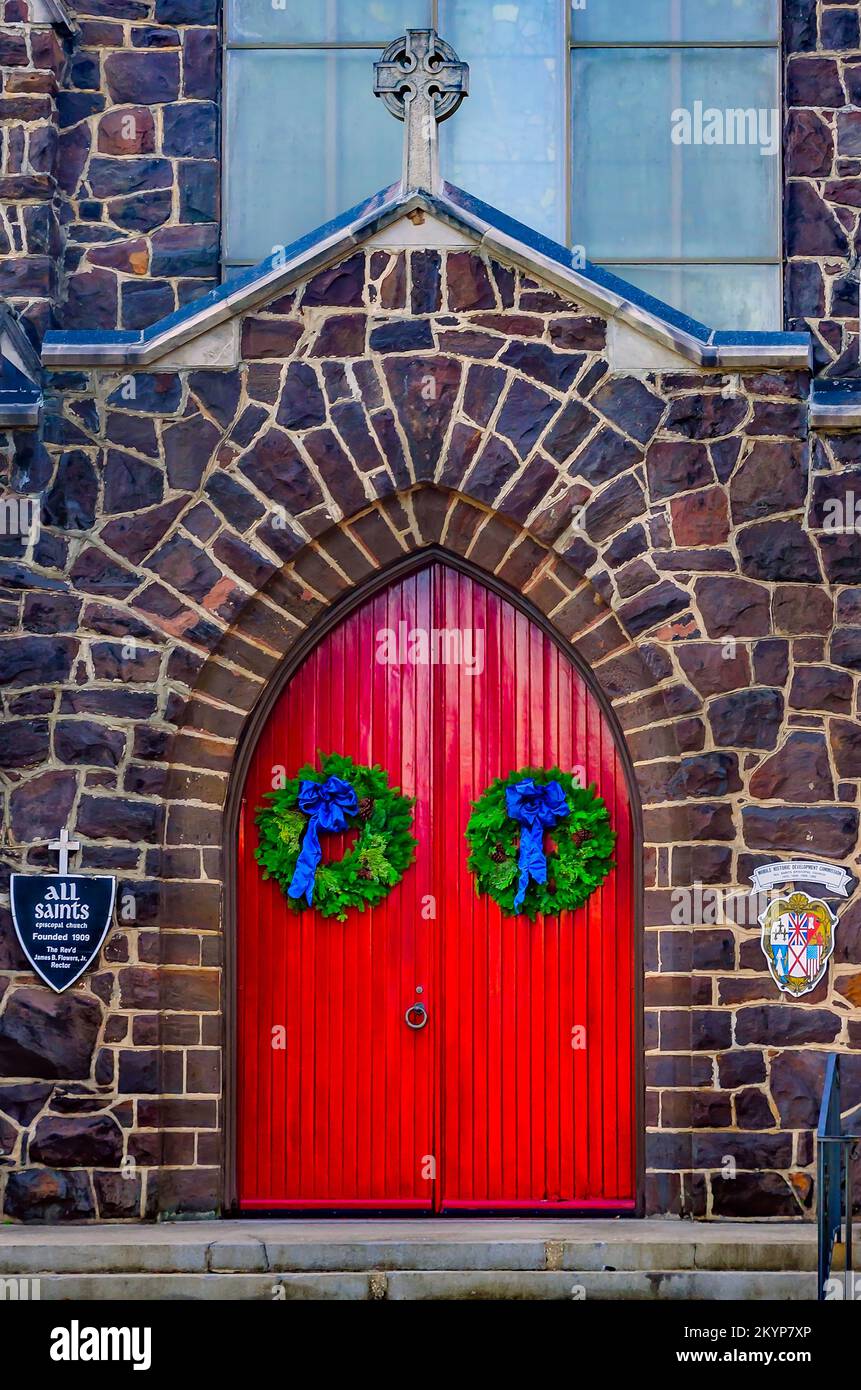 Christmas wreaths hang on the red doors of All Saints Episcopal Church on Government Street, Nov. 30, 2022, in Mobile, Alabama. Stock Photo