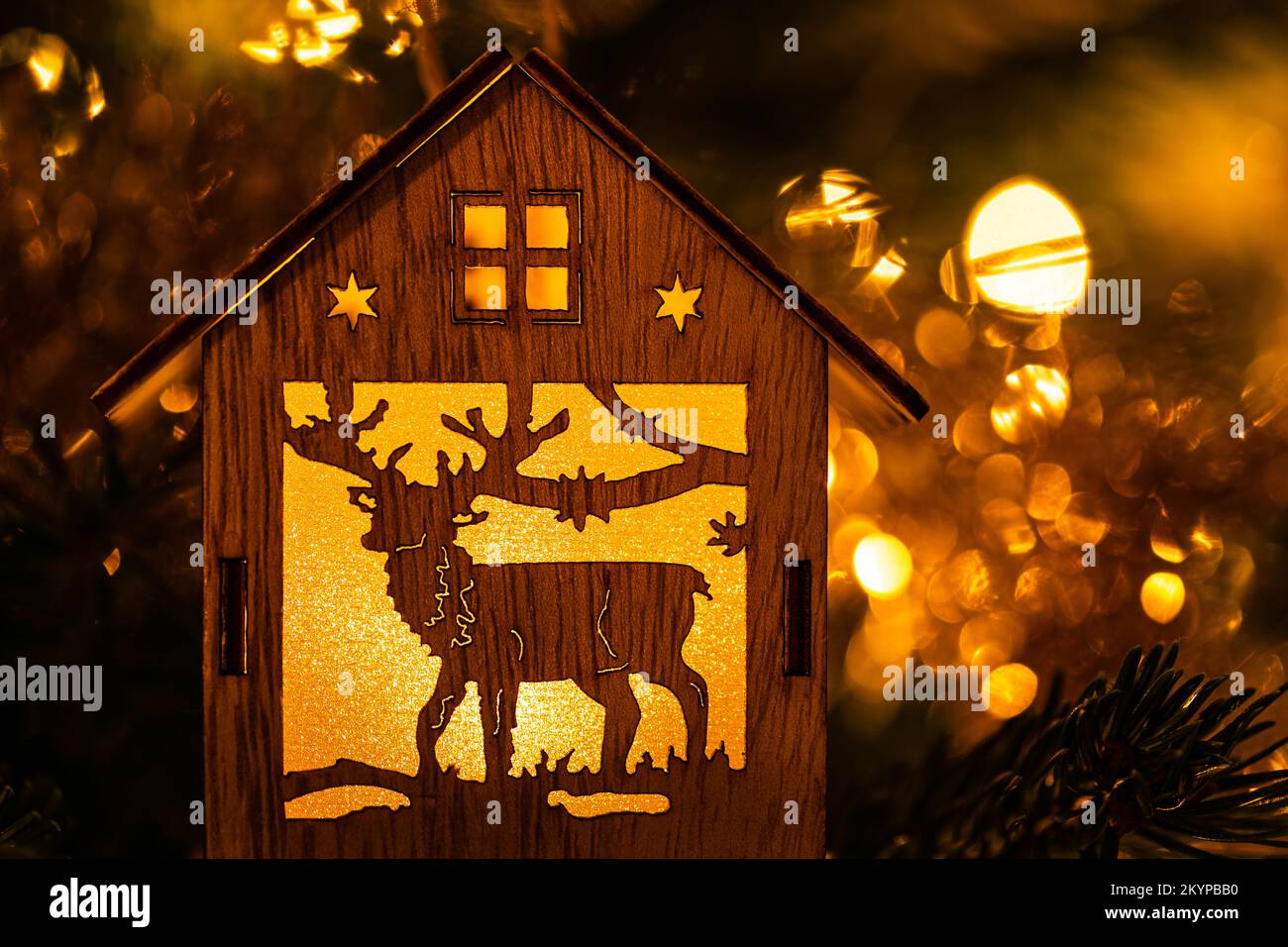 Christmas decoration in the shape of a house with a reindeer inside lit ...