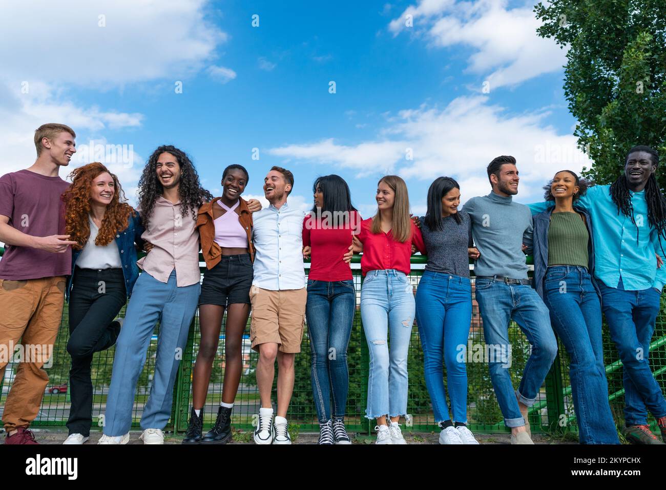 Group of international friends bonding outdoors - Multicultural people laughing outside Stock Photo
