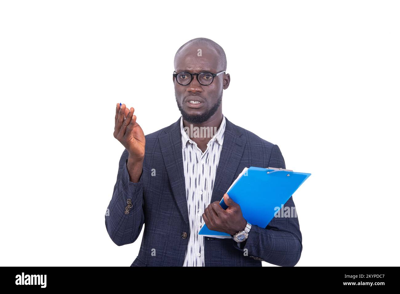 a young man in jacket standing on white background holding a folder and speaking with hand gesture. Stock Photo