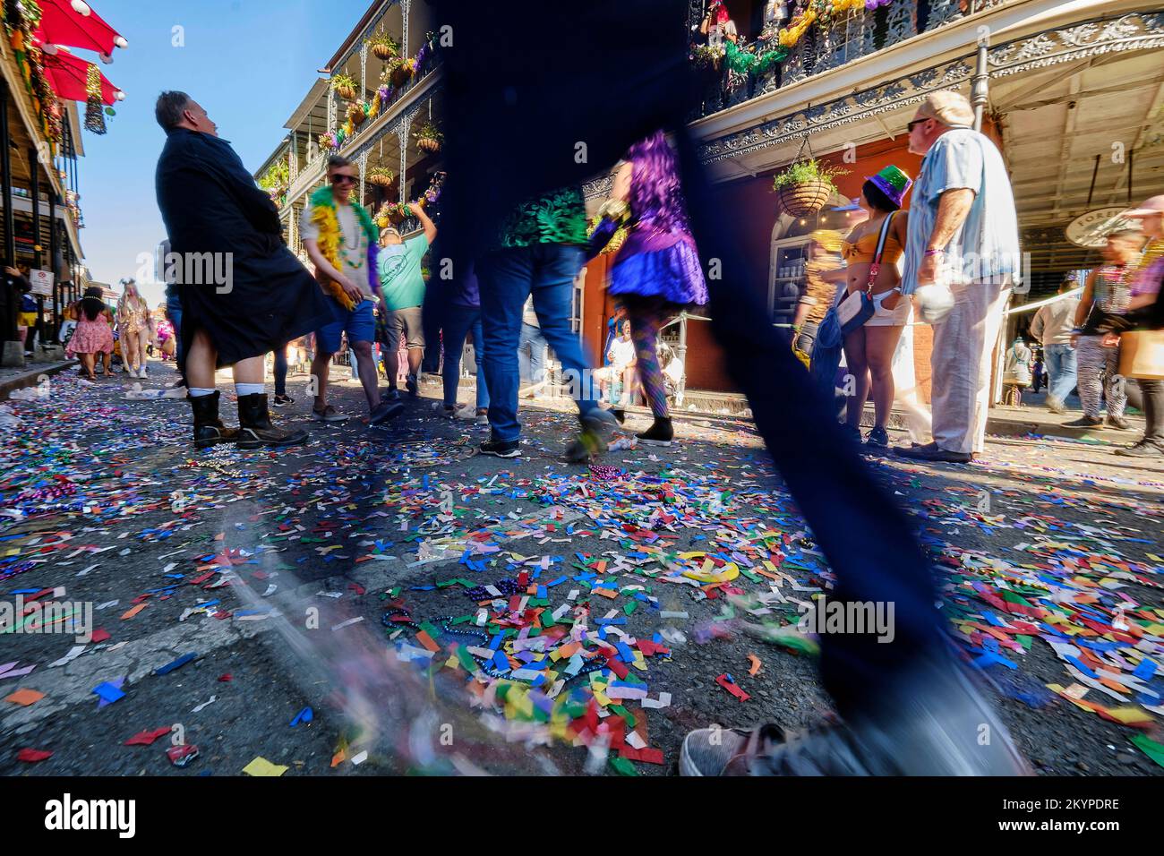 New Orleans, Louisiana, USA. 1st Mar, 2022. People walk through the confetti and bead covered streets of the French Quarter during Fat Tuesday Mardi Gras celebrations in New Orleans, Louisiana USA on March 01, 2022. Mardi Gras parades and festivities were cancelled in the city last year due to the Covid-19 pandemic. (Credit Image: © Dan Anderson/ZUMA Press Wire) Stock Photo