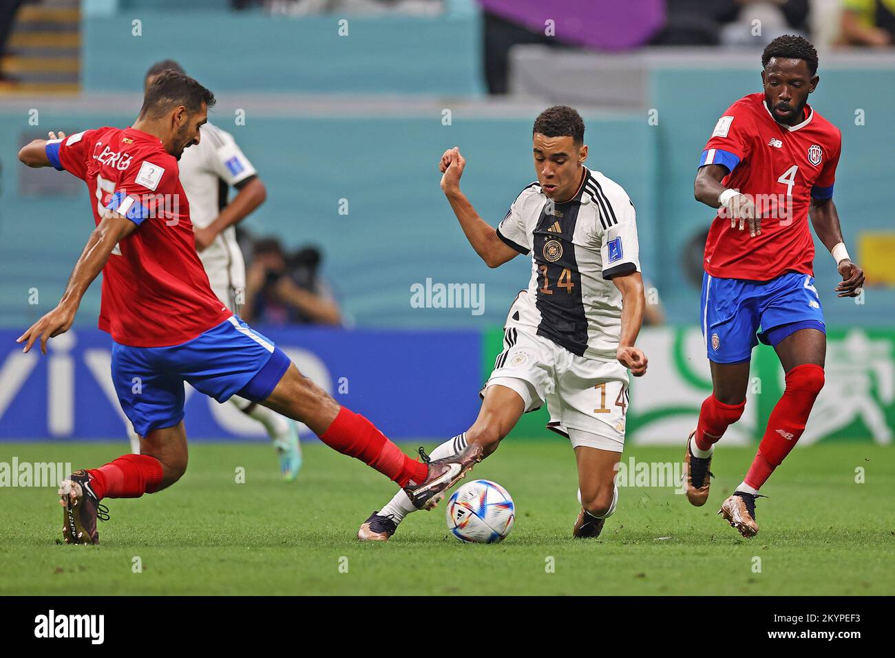 1st December 2022; Al Bayt Stadium, Al Khor, Qatar; FIFA World Cup Football, Costa Rica versus Germany; Celso Borges and Keysher Fuller of Costa Rica block off Jamal Musiala of Germany Stock Photo