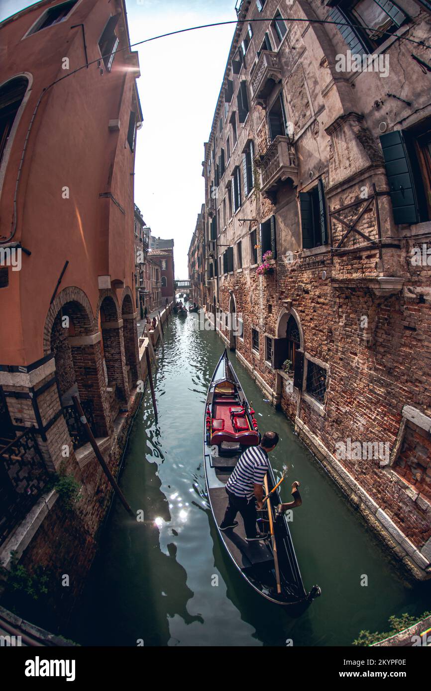 Image of canals in Venice with their gondolas, bridges and tourists