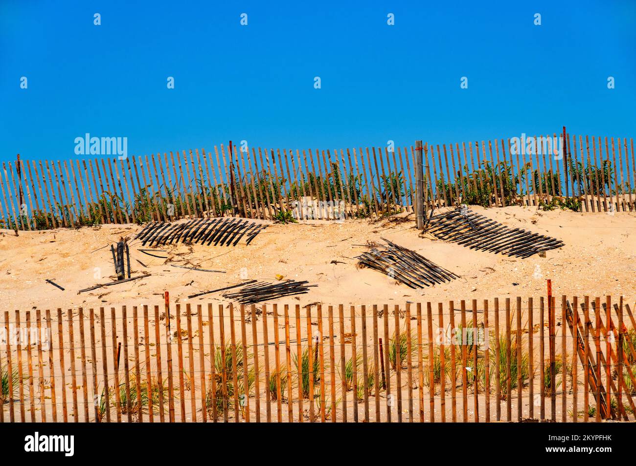 Picket fences on a sandy beach Stock Photo