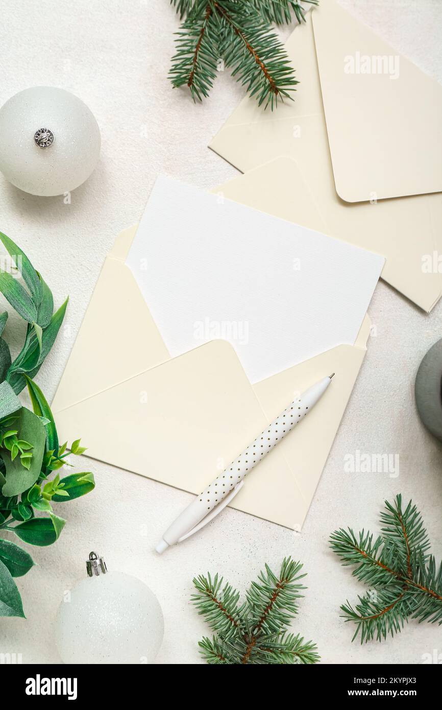 Envelopes with blank card, Christmas branches and balls on white ...