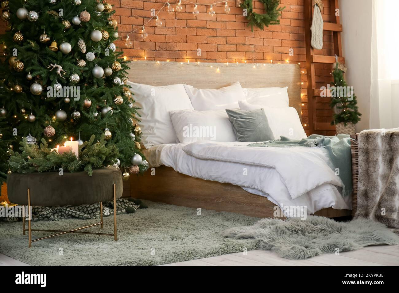 Interior of bedroom with Christmas trees and glowing lights Stock Photo