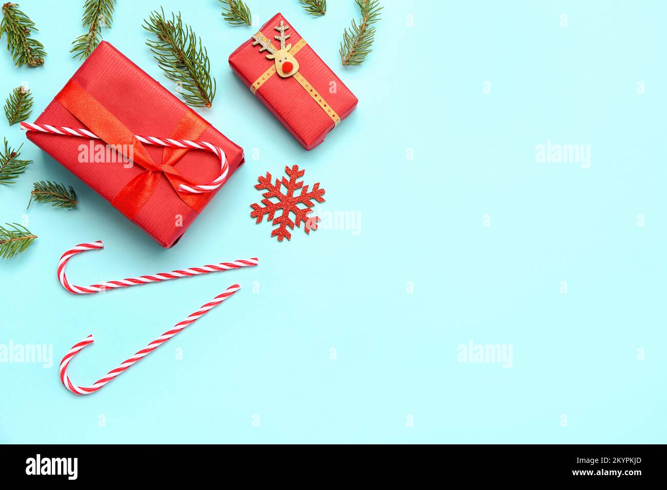 Christmas gift boxes with candy canes and fir branches on blue ...